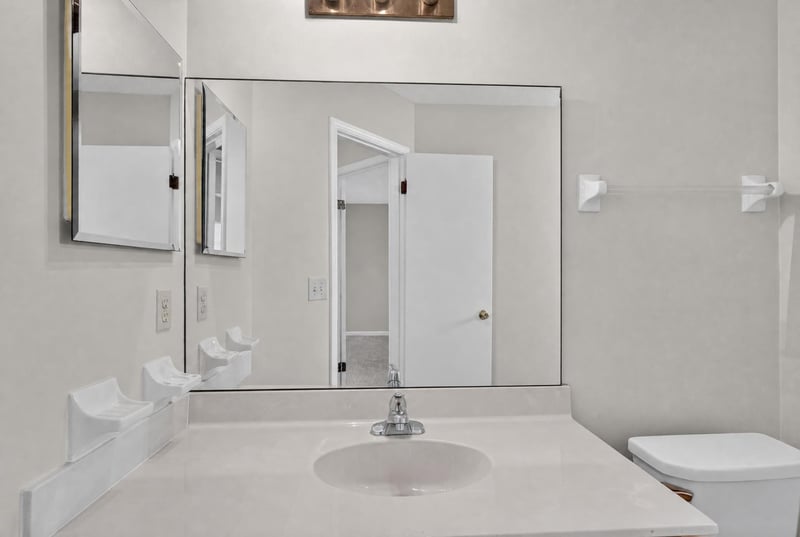 Bathroom vanity mirror with sink and toilet at 400 Ashcroft Landing Dr, Jacksonville, FL 32225