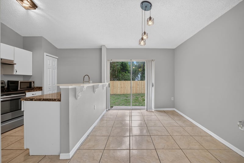 Kitchen with granite counter and breakfast bar at 7329 Lawn Tennis Ln, Jacksonville, FL