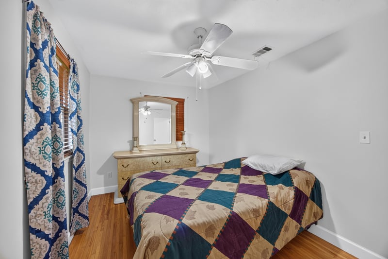 Bedroom with dresser and patterned curtains at 1847 Grove Park Dr, Orange Park, FL