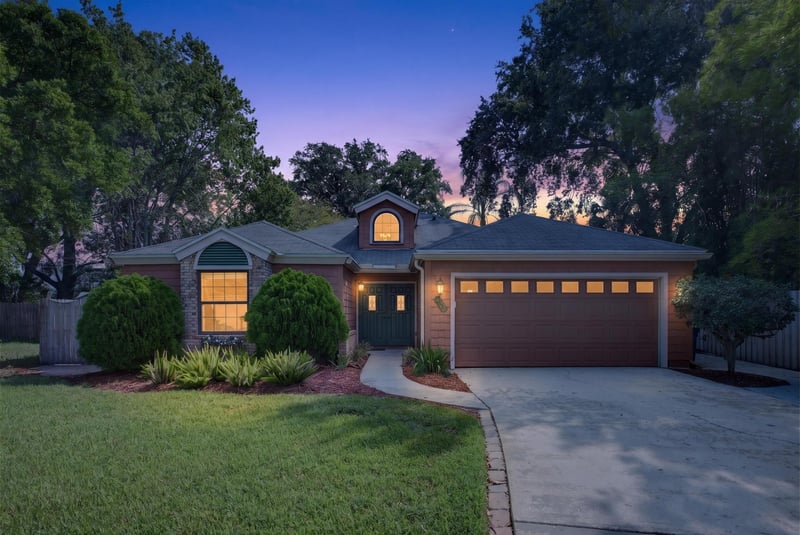 Front exterior with dormer windows at day-to-dusk at 4837 Pareja Ct, Jacksonville, FL 32225
