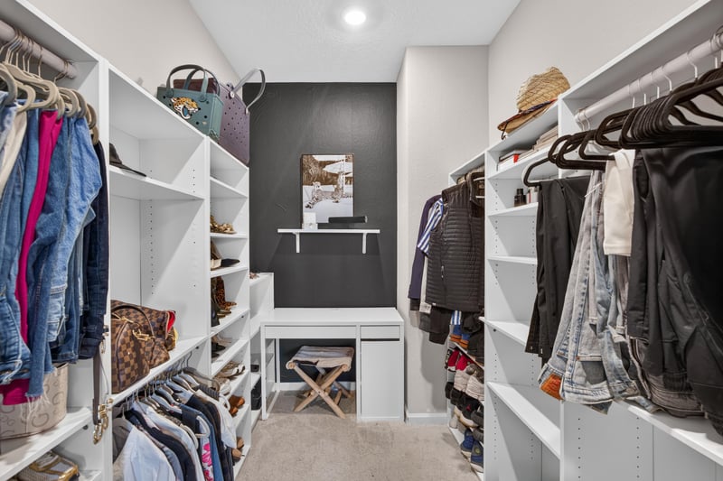 Primary walk-in closet with built-in shelving at 9942 Lovage Ln, Jacksonville, FL 32219