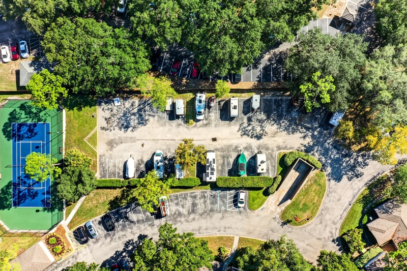 Aerial view of parking area and tree-lined condo community in Jacksonville, FL