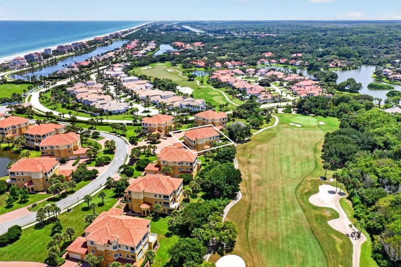 Aerial of community waterway and rooftops in Palm Coast, FL