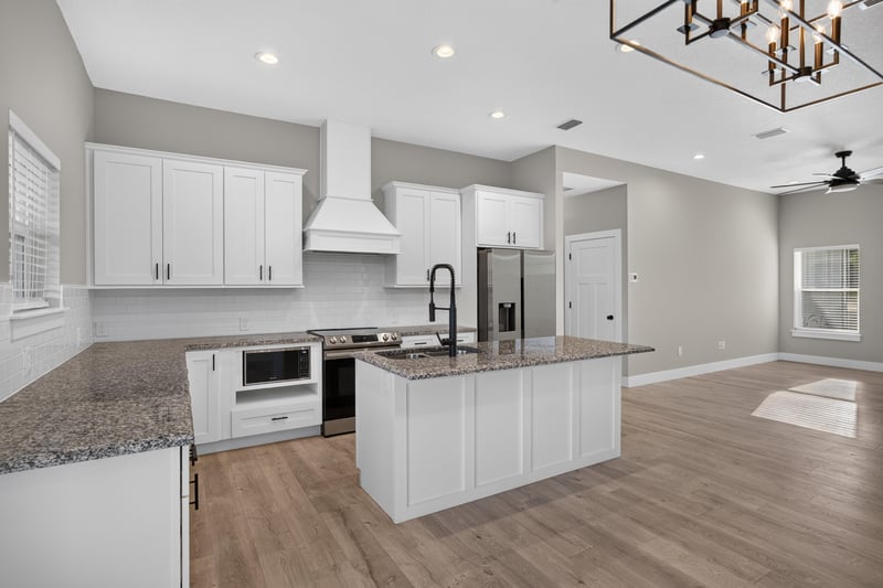 Kitchen island with range and stainless appliances at 175 Alava Ct