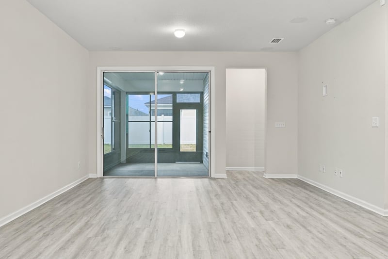Open living area with sliding glass doors at 7088 Mahogany Run Dr, Jacksonville, FL 32244