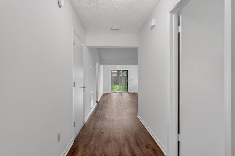 Interior hallway with wood-look flooring at 1445 Classic Oak Rd W, Jacksonville, FL