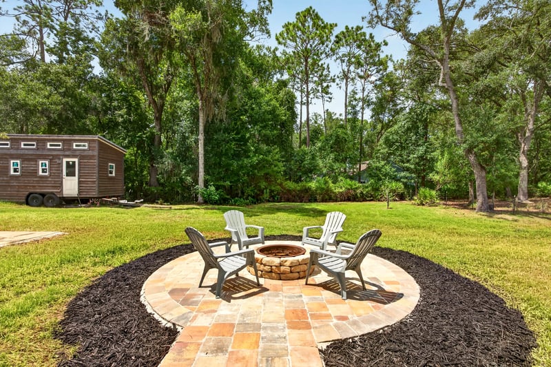 Fire pit seating area near small structure at 1161 Whispering Pines Rd, Jacksonville, FL 32259