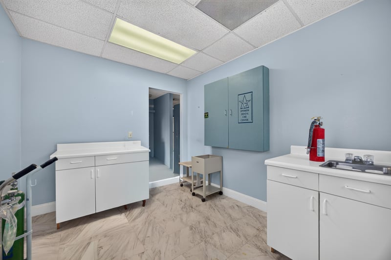 Room with wall cabinets and mounted fire extinguisher at 1543 Kingsley Ave #19, Orange Park, FL 32073