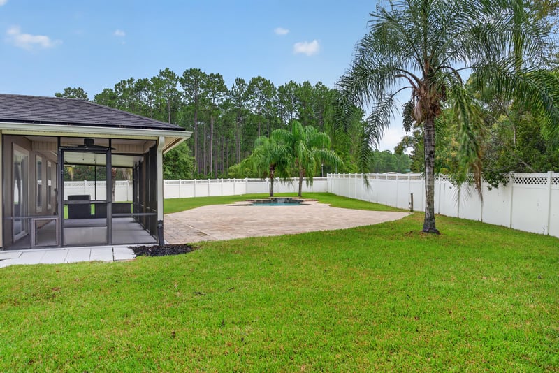 Backyard patio structure and lawn at 706 Grampian Highlands Dr, St. Johns, FL 32259