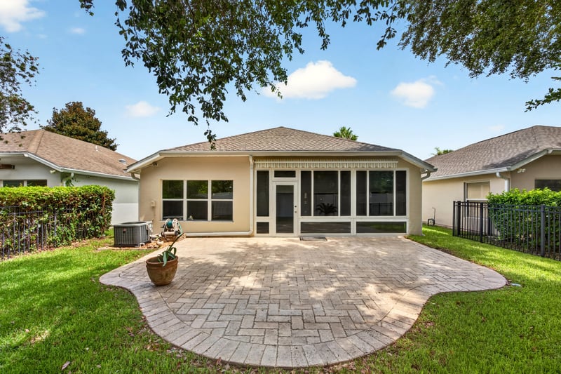 Backyard view of screened porch and patio at 11225 Water Spring Cir, Jacksonville, FL 32256