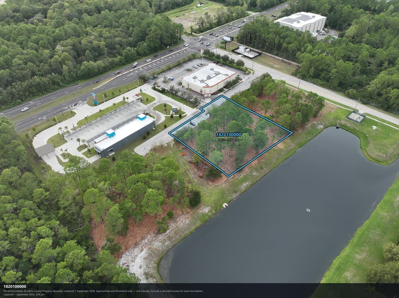 Aerial view of the pond and parcel boundary with tree cover at 4900 US-1, St. Augustine, FL 32086
