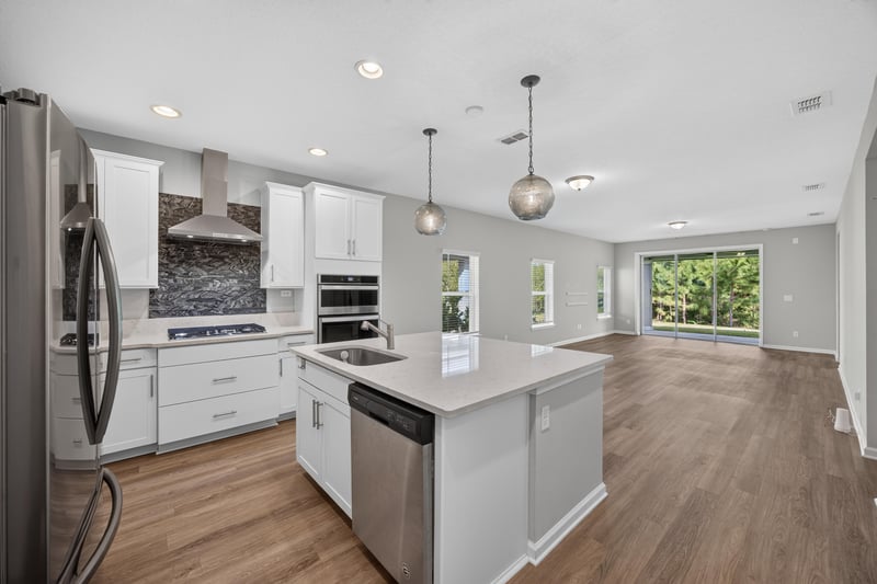 Kitchen with white cabinets and stainless range hood at 75875 Saffron Ln, Yulee, FL 32097