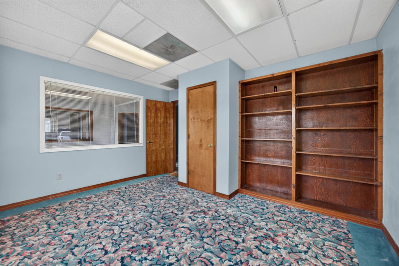 Room with pass-through window and built-in shelving at 1543 Kingsley Ave #19, Orange Park, FL 32073