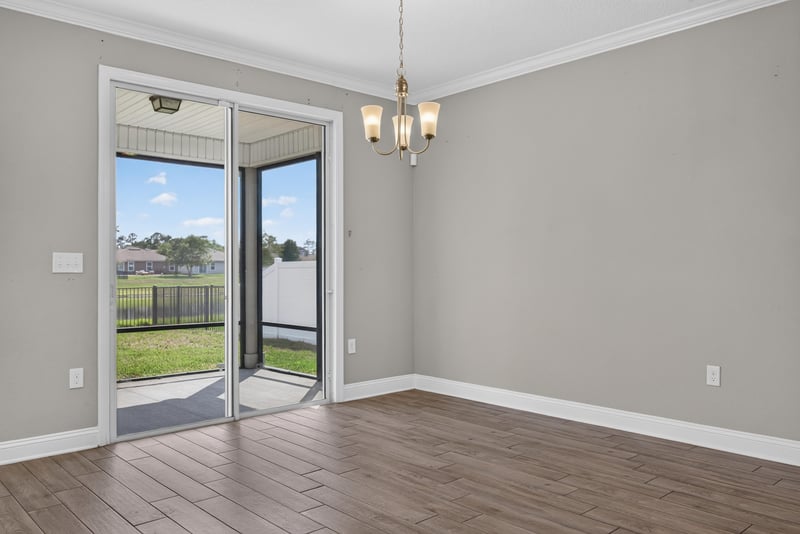 Dining area with sliding glass door and chandelier at 2580 Cold Stream Ln, Green Cove Springs, FL 32043