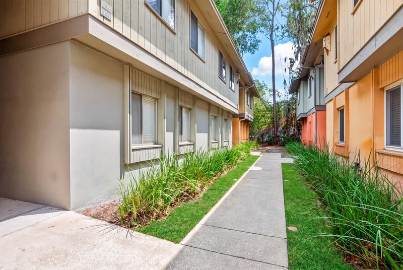 Building exterior and landscaped walkway at 1800 Park Ave apt 358, Orange Park, FL