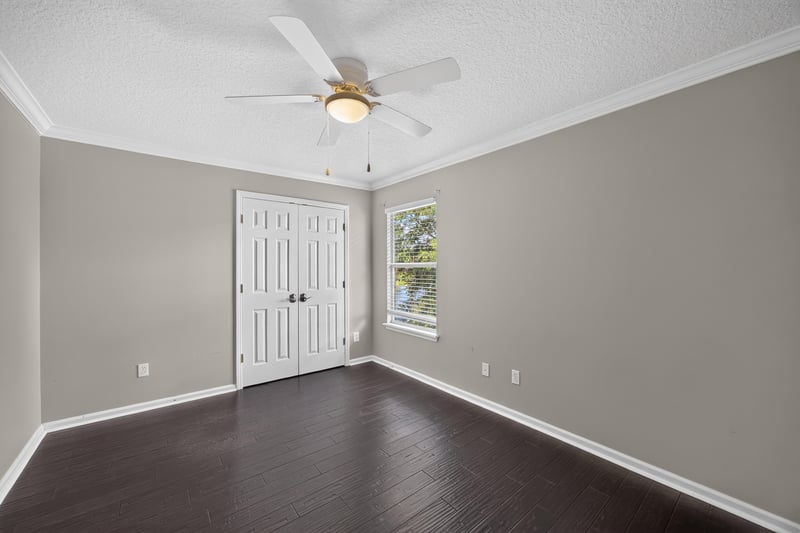 Bedroom with ceiling fan and closet door at 1493 Greyfield Dr, St. Augustine, FL 32092