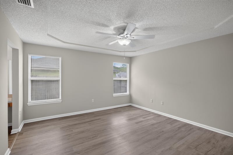Bedroom with ceiling fan and window at 8519 Blazing Star Ct, Jacksonville, FL 32210