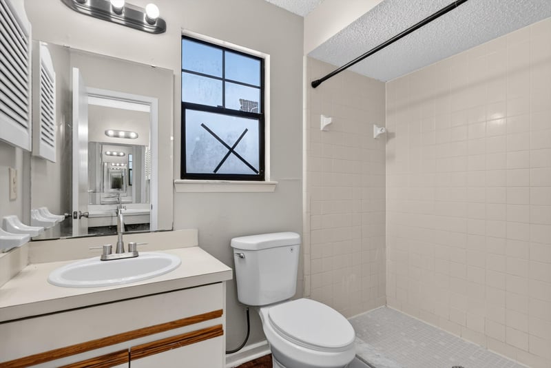 Bathroom vanity with window at 8010 International Village Dr, Jacksonville, FL 32277