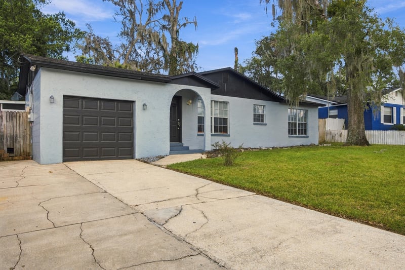 Front exterior with driveway and garage door at 417 Capricorn Ln, Orange Park, FL 32073