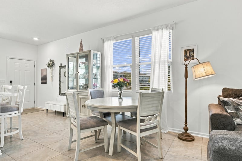 Dining table near staircase with natural light at 8359 Zenith Cir, Jacksonville, FL 32256
