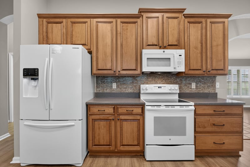 Kitchen with refrigerator and white appliances at 1955 GUARDED Way, Fleming Island, FL 32003