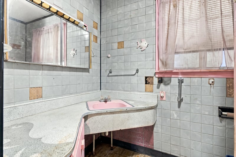 Bathroom with pink tile and built-in tub at 1807 Idlewild Ave, Green Cove Springs, FL