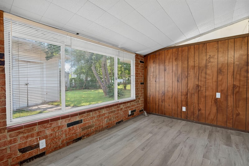 Room with wood paneling and windows at 5503 Boeing Dr, Jacksonville, FL 32207