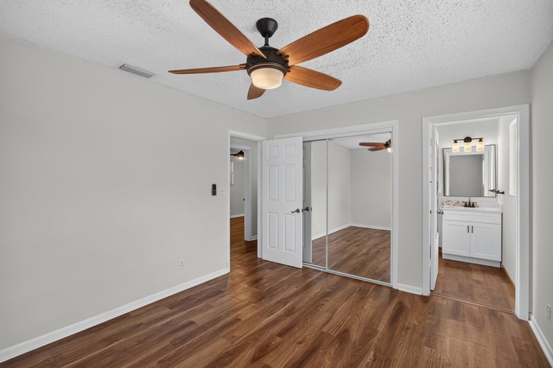 Bedroom with mirrored closets and hallway view at 4039 Habana Ave, Jacksonville, FL