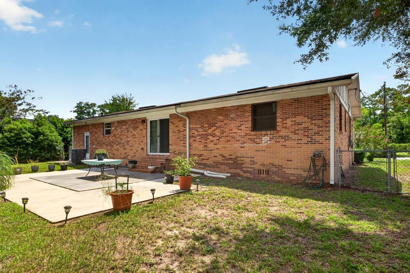 Backyard patio and lawn view at 1847 Grove Park Dr, Orange Park, FL