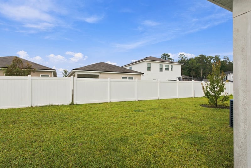 Fenced backyard with grass at 7088 Mahogany Run Dr, Jacksonville, FL 32244