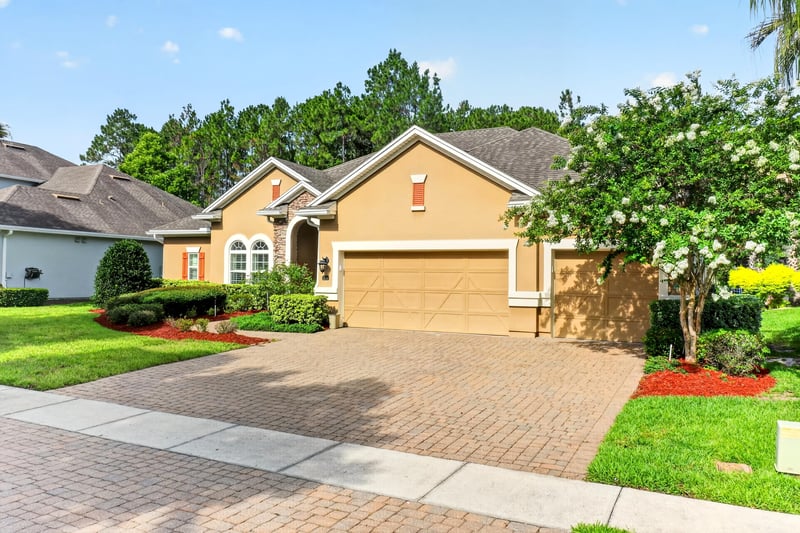 Front exterior with paver driveway and landscaped lawn at 276 Cross Ridge Dr, Ponte Vedra Beach, FL 32081