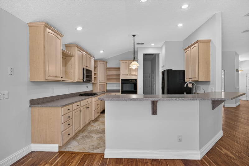 Kitchen panorama with wood cabinets and island at 11675 Magnolia Estates Rd, Jacksonville, FL 32223