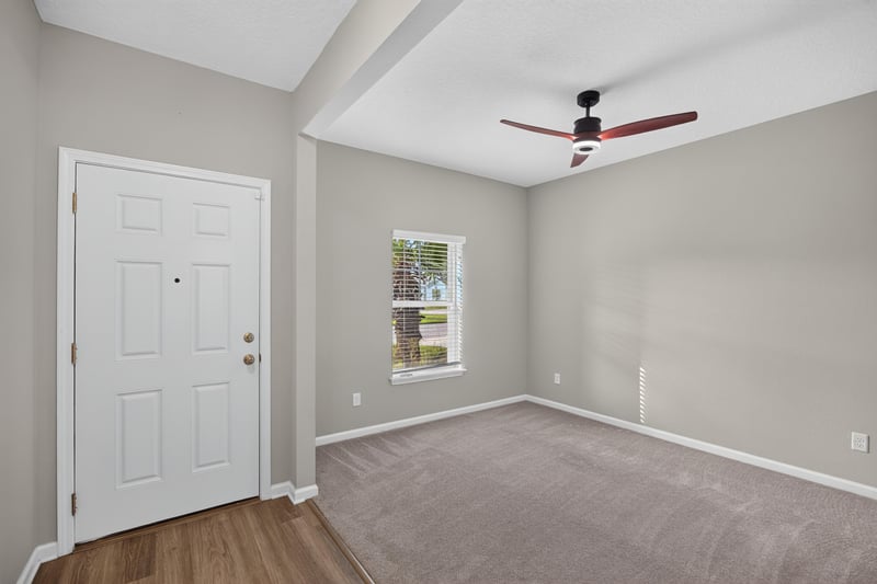 Entry foyer with front door and ceiling fan at 75875 Saffron Ln, Yulee, FL 32097