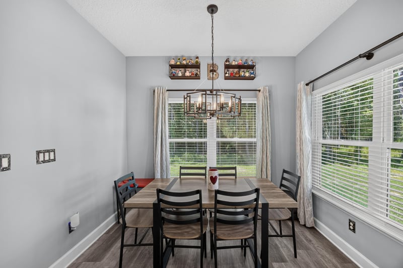 Dining area with wood table and chandelier at 2817 Camel Cir, Middleburg, FL