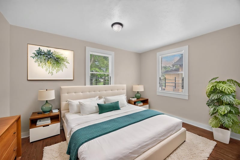 Virtually staged bedroom with bed and plant at 1473 State St W, Jacksonville, FL 32209