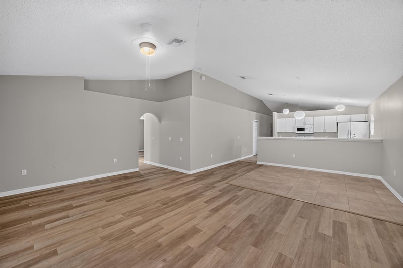 Open living and kitchen area with pass-through at 1845 Saga Ct, Middleburg, FL