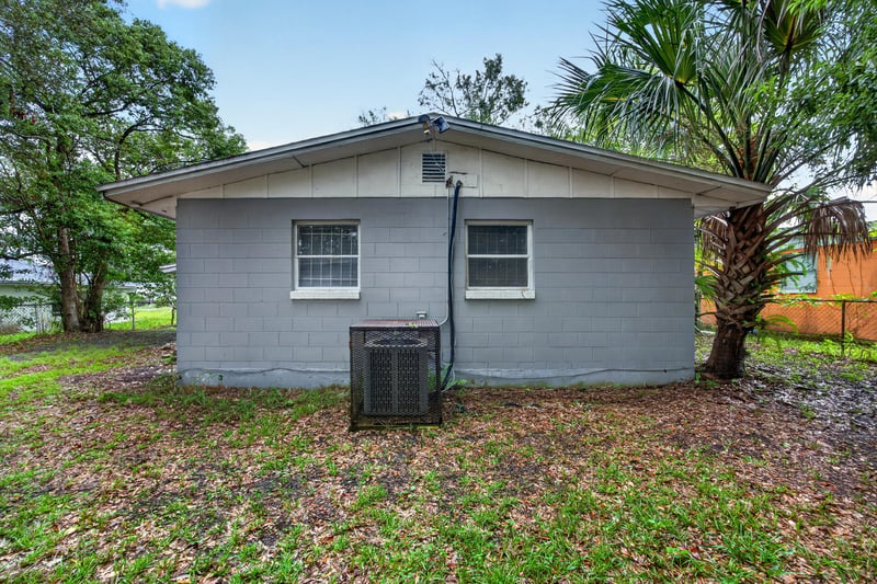 Rear exterior view with AC unit near side door at 4030 Leonard Cir W, Jacksonville, FL 32209