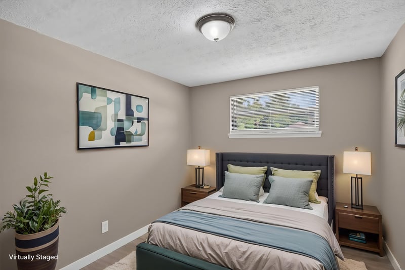Virtually staged bedroom with artwork and bed at 184 Draco St, Orange Park, FL 32073