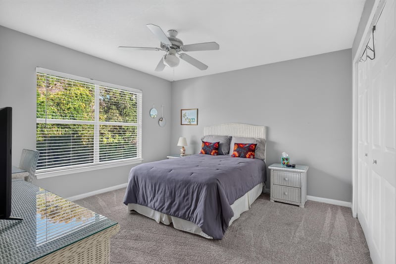 Second bedroom with bed and window at 206 16th St, St. Augustine, FL 32080