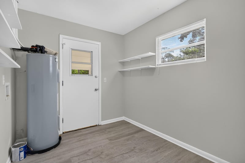Utility room with water heater and door at 5503 Boeing Dr, Jacksonville, FL 32207