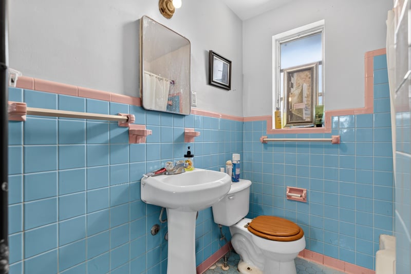 Bathroom with blue tile and pedestal sink at 450 E 46th St, Jacksonville, FL 32208