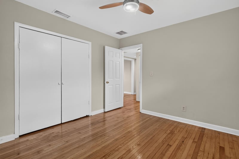 Bedroom with wood floors and double closet doors at 217 Baisden Rd, Jacksonville, FL 32218