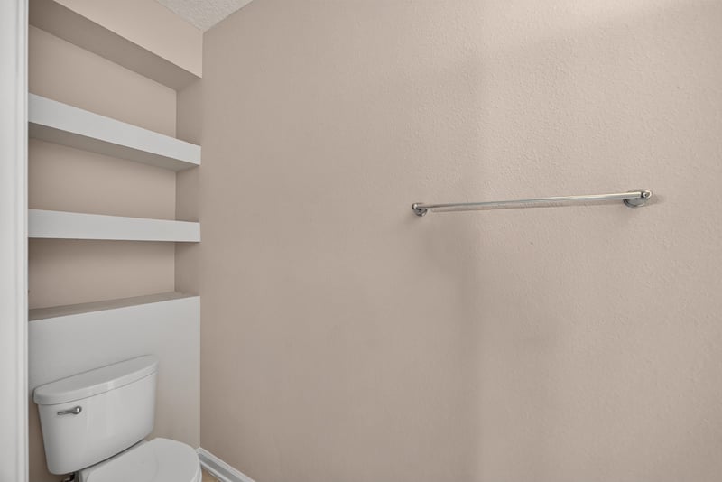 Built-in storage shelving under stairs at 3762 Hartsfield Forest Cir, Jacksonville, FL 32277