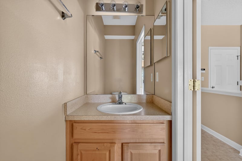 Bathroom vanity with mirror at 12359 Mangrove Forest Ct, Jacksonville, FL 32218