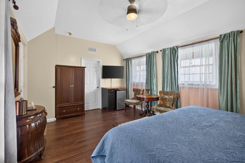 Bedroom seating area with wood cabinetry at 115 Cordova St, St. Augustine, FL