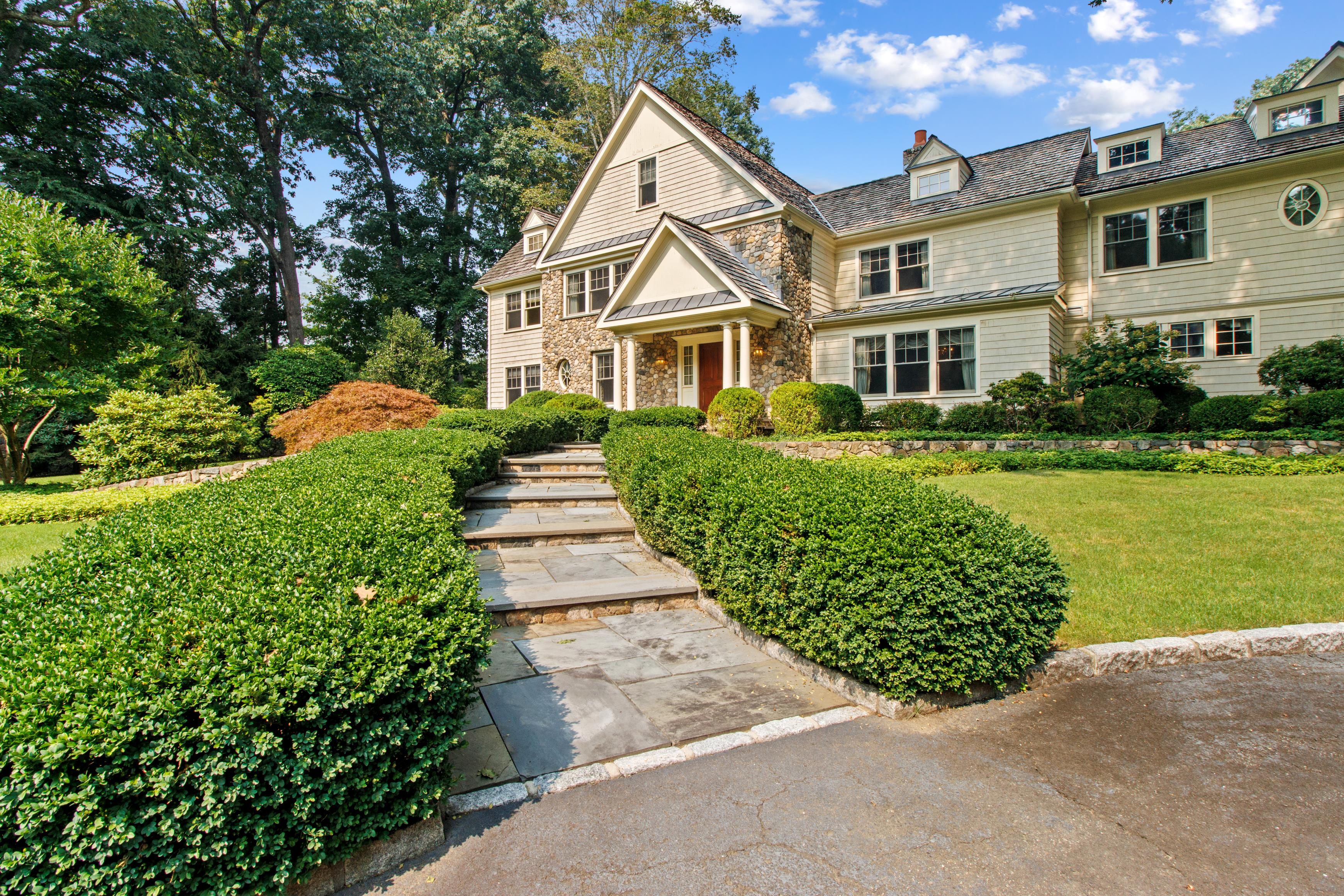 Elegant estate photographed by PXV Media, framed by landscaped gardens