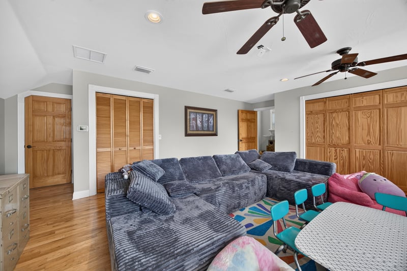 Bonus room with closet doors and sectional sofa at 1735 Hagans Ridge Ct