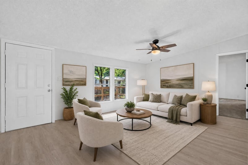 Virtually staged living room with sofa and ceiling fan at 55520 Jewel-Thomas Rd, Callahan, FL 32011