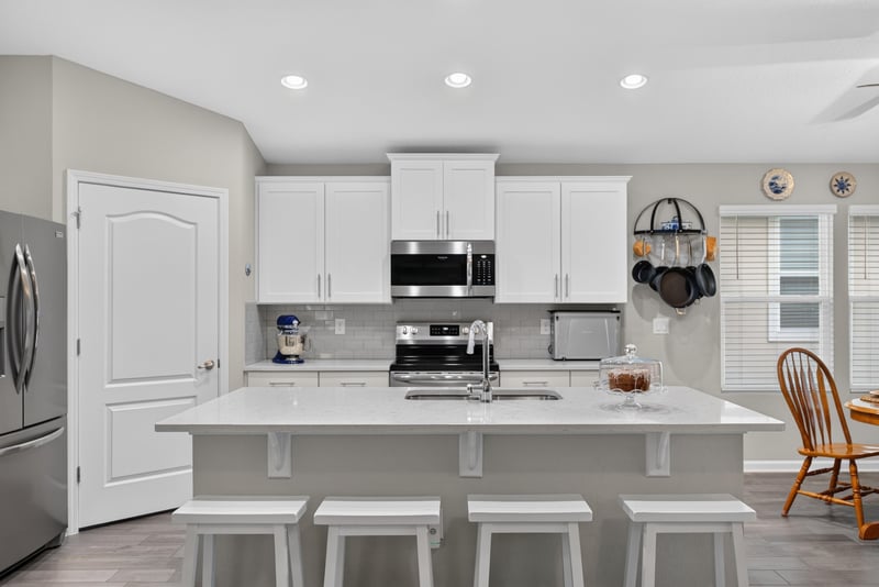 Kitchen island with bar stools at 4319 Green River Pl, Middleburg, FL 32068