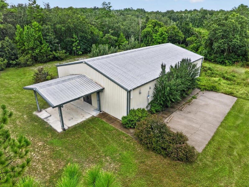 Aerial side view of building roof and walkway with covered entry at 1038 County Rd 315, Melrose